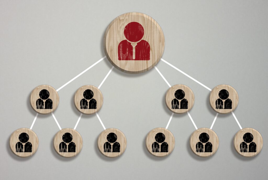Wooden block featuring a staff icon, symbolizing connection, collaboration, or teamwork in a business or professional context