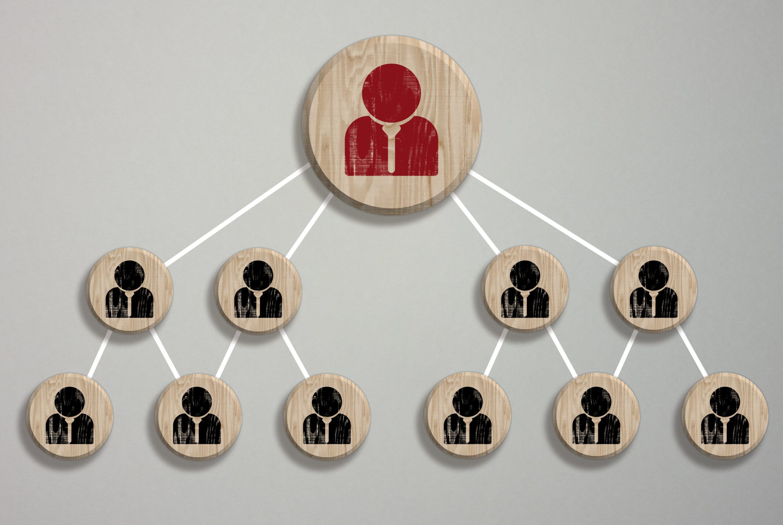 Wooden block featuring a staff icon, symbolizing connection, collaboration, or teamwork in a business or professional context